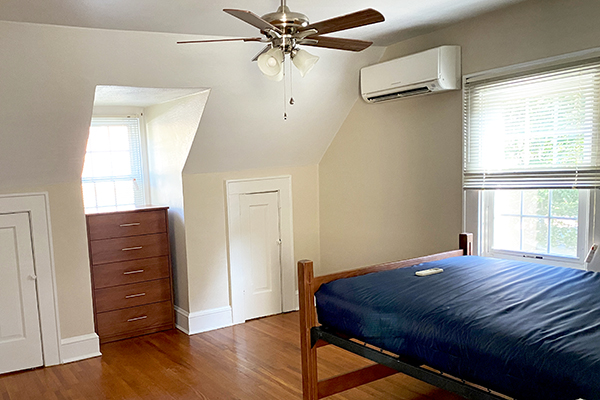 Recovery Housing bedroom with lofted bed, dresser, ceiling fan, and wooden floors