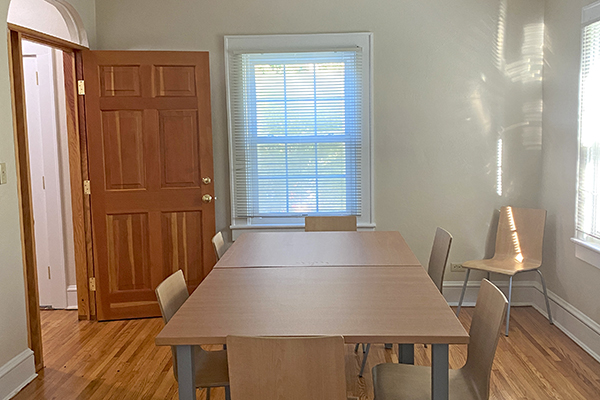 Recovery Housing dining room with table and chairs, wooden floor