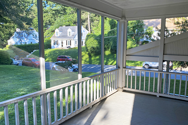 Recovery Housing screened-in porch overlooking grassy yard in residential area