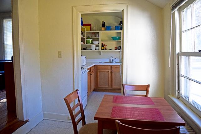 Dining area adjacent to kitchen includes table and chairs