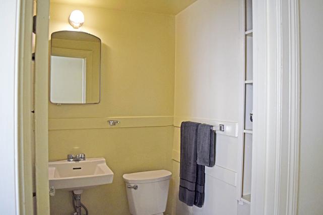 Bathroom has a standard bathtub/shower and ample storage space
