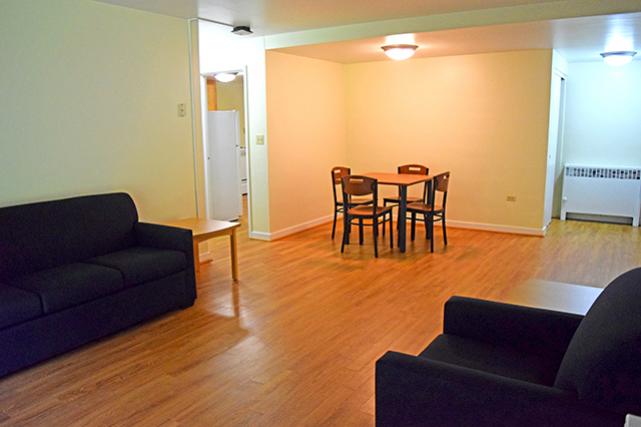 Furnished apartments include a sofa, chair, end tables, and dining table and chairs 