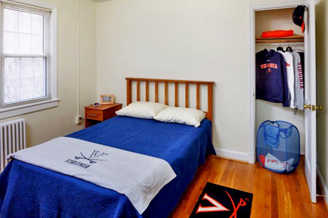 Double bed, nightstand, and closet in furnished apartment