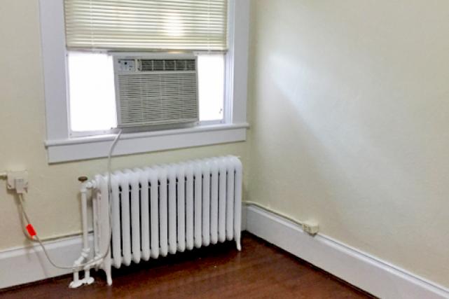 Upper apartment dining room with window air conditioner